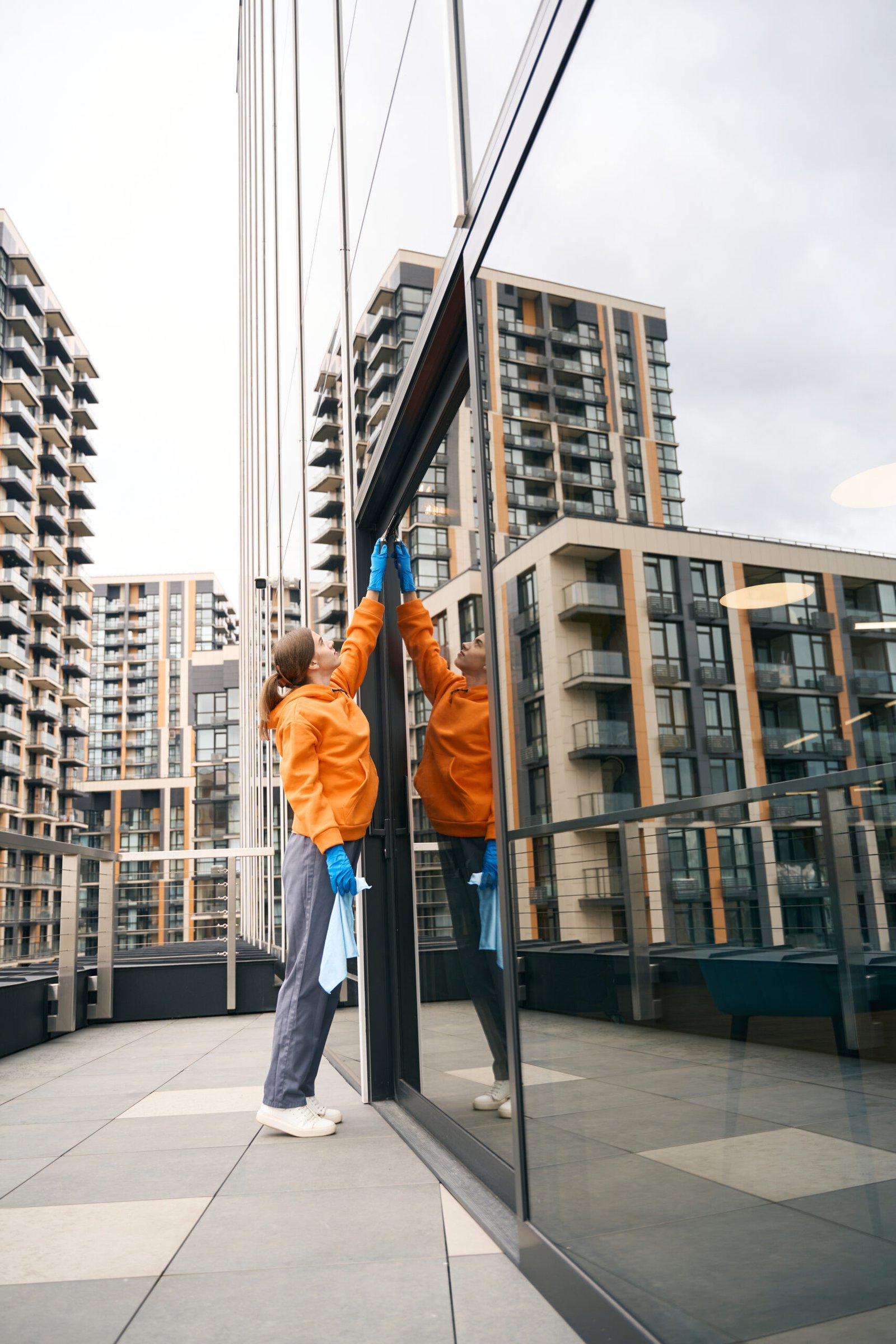 A window cleaner using safety equipment on a tall building.