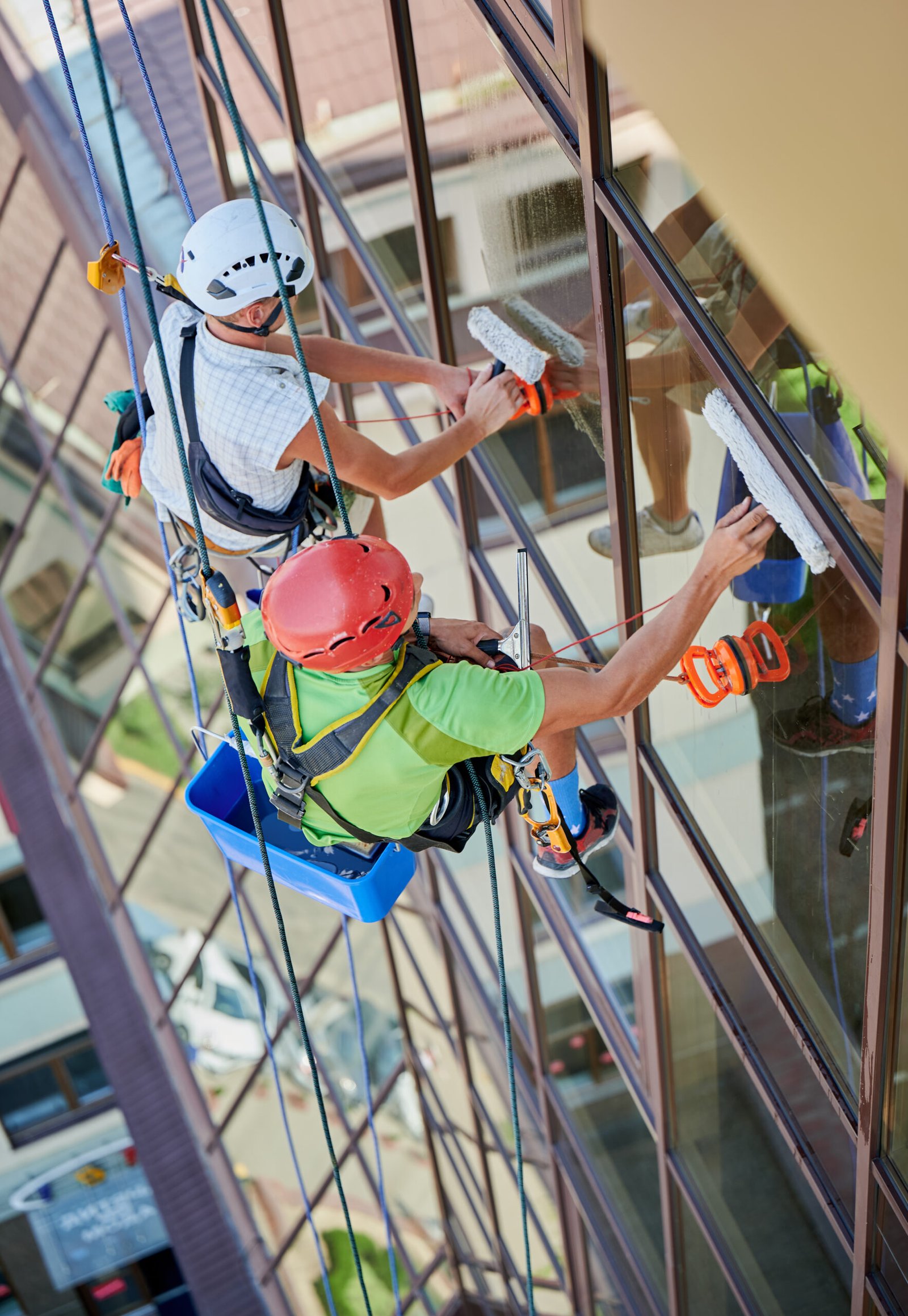 A professional cleaner wiping an exterior window.